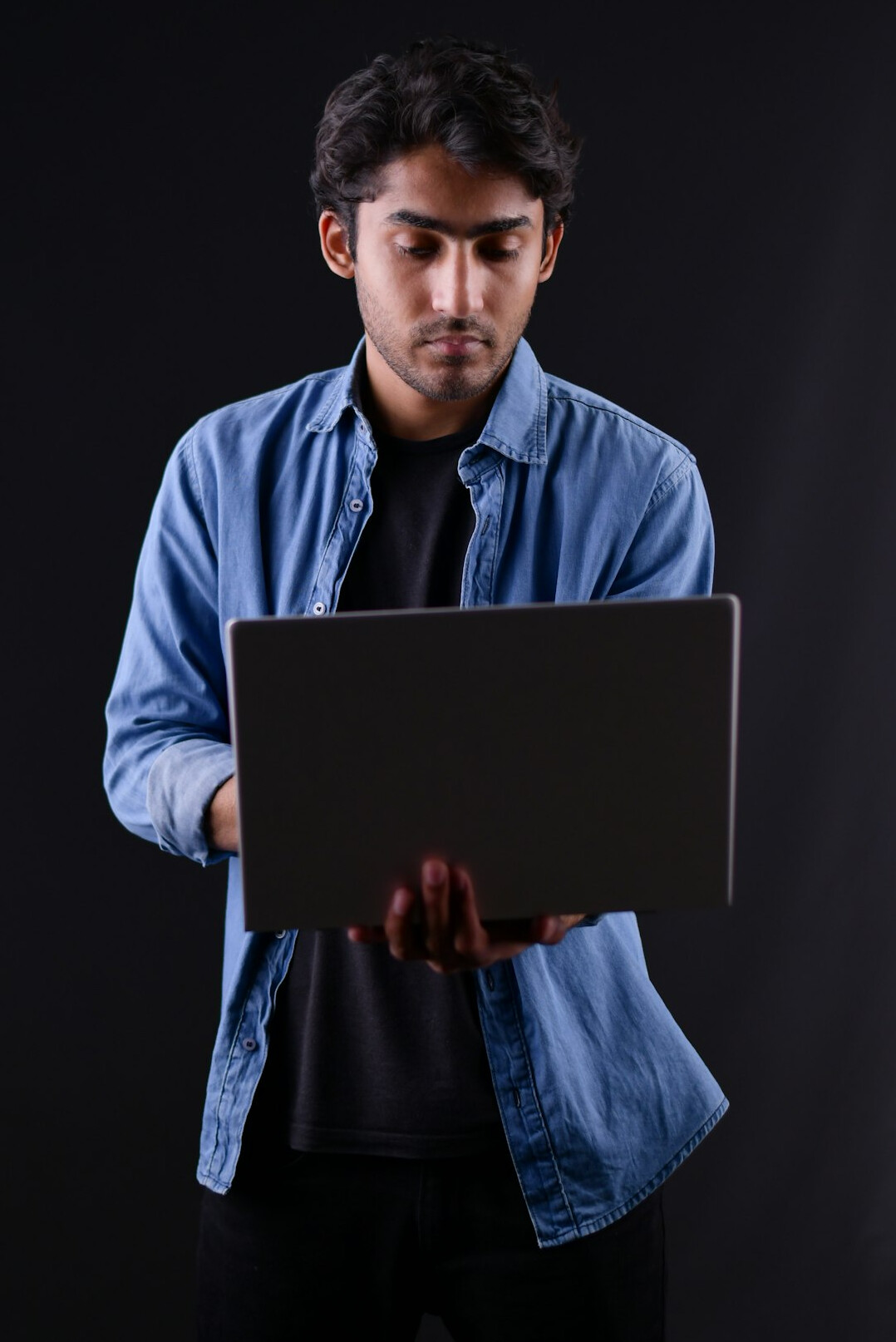 young man studying code on laptop