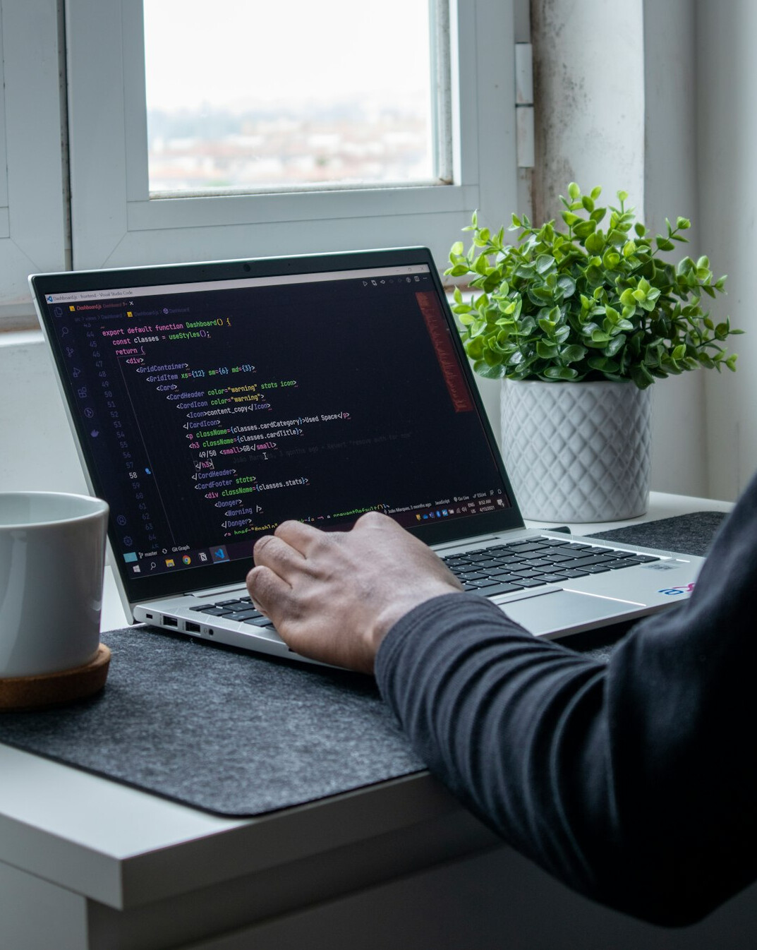 person coding on laptop at home