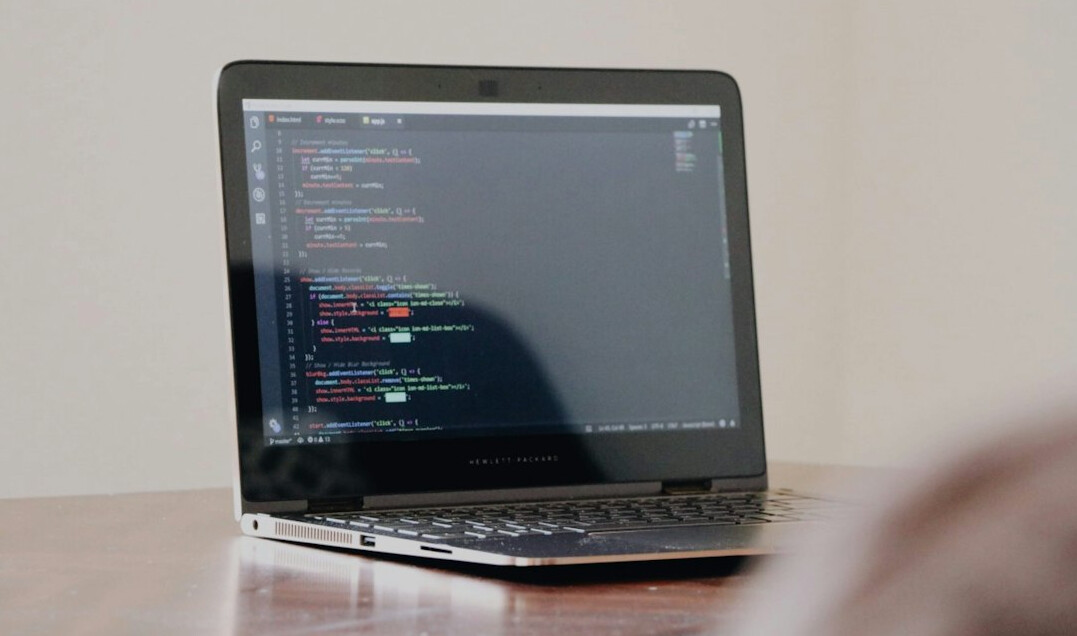 programmer coding on laptop